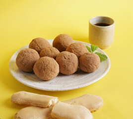 Tiramisu Flavored Chocolate balls on yellow background , Sweet Mini Balls for Snacks.