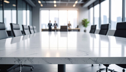 Close-up of a wide conference desk against a blurry modern bright office with worker background.