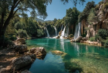 Naklejka premium Serene Waterfall Surrounded by Lush Green Trees and Clear Blue Water in a Beautiful Natural Landscape