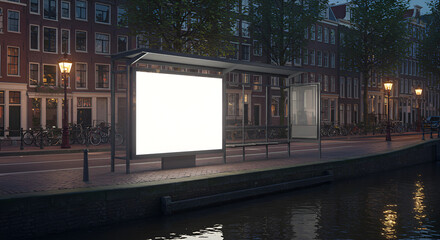 Fototapeta premium Empty billboard on a canal-side bus stop at night
