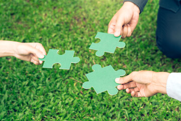 group of business people assembling jigsaw puzzle. The concept of cooperation, teamwork, help and support in business.