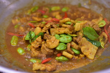 Spicy stir fried pork with Cluster Bean (Bitter Bean or stink beans) popular southern Thai food, Spicy stir fried chicken with Cluster Bean (Bitter Bean or stink beans).Thai southern food