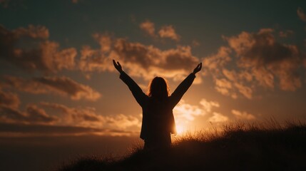 Silhouette of woman raising arms at sunrise on hilltop with dramatic clouds symbolizing hope, freedom and inner peace ideal for International Day of Peace, meditation and empowerment visuals