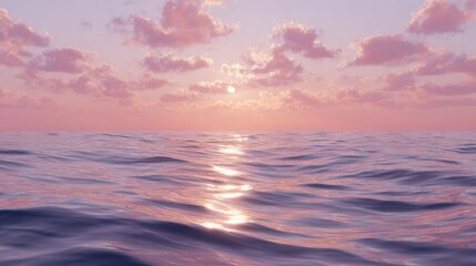 Fototapeta premium Sunset view across open water with glowing sky colors and smooth gentle waves