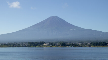 Mount fuji san at Lake kawaguchiko in japan on Day.Fisherman with beautiful sunrise mood of Fuji Mountain at Yamanaka lake.