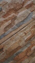 the background of the house wall uses natural stone