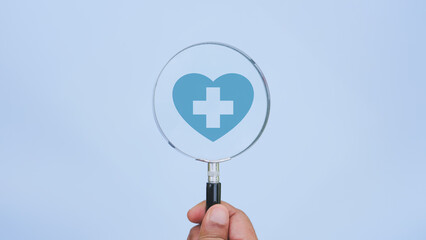 Health insurance concept. Health care checkup and healthy trends. Access to welfare health. Wellness and medical. Magnifying glass ang Healthcare insurance icon on blue background. World health day