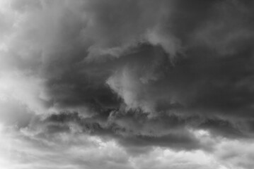 Dark storm clouds gathe in the sky creating an ominous atmosphere with strong descending weather...