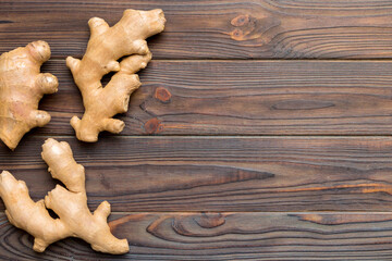 Finely dry Ginger powder in bowl with green leaves isolated on colored background. top view flat lay