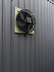 Dusty ventilation fan on  wall

