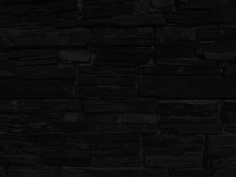Enigmatic Black Stone Wall: Textured and Tightly Stacked Stones for a Modern Minimalist Background