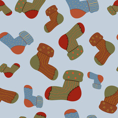Cozy seamless pattern of warm handmade socks on a light blue background. Perfect for wrapping paper, digital backgrounds, and comfort-themed seasonal designs.