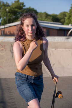 Young girl riding on her skateboard, outdoor kids activities