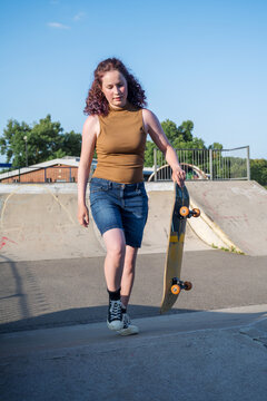 Young girl riding on her skateboard, outdoor kids activities