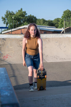 Young girl riding on her skateboard, outdoor kids activities