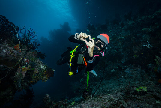 Scuba diver swimming towards camera in Raja Ampat