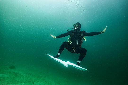 diver using his fins for surfing in Raja Ampat