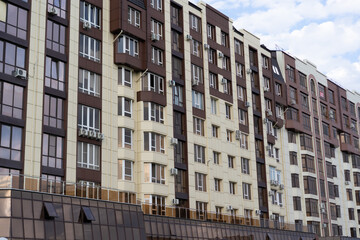 Modern residential building showcasing architectural design and air conditioning units in a bustling urban area