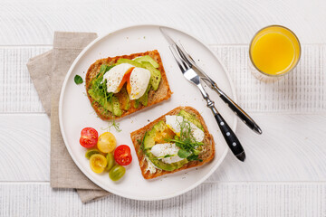 Delicious avocado toasts topped with perfectly cooked poached eggs