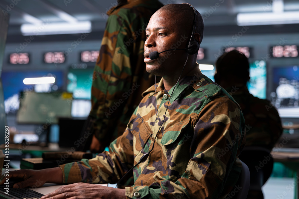Poster agent in command post uses gear to identify threats from enemies. african american army operator in 