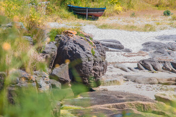 Secluded beach in a cove in Galicia, Spain: summer vacation with turquoise waters