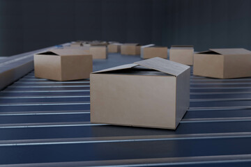 3D rendering of conveyor belt with cardboard boxes moving along, concept of shipping, delivery logistics, and modern warehouse automation
