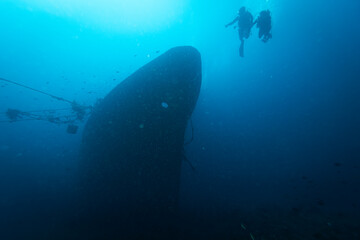 Two Divers Explores the Relax Wreck at Dive Site on the Island of Bali, Indonesia.