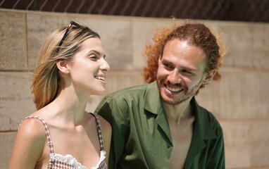 Headshot of young man and woman multiethnic couple laughing and having fun together on a sunny...