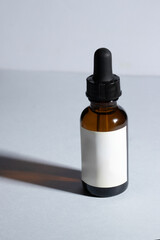amber glass serum bottles with moke up tag  at white background.Modern skincare, beauty rituals, and cosmetic treatments.