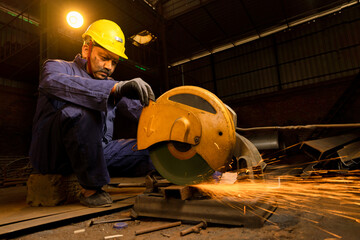 Cutting of a steel with splashes of sparks in the industrial shop