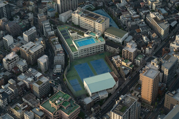 Aerial view of city buildings with rooftop sports facilities