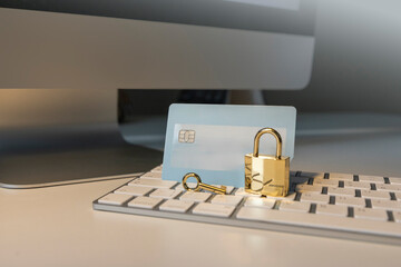 Cyber security and data protection concept. Debit card is locked on locker. Key, lock, keyboard, computer.