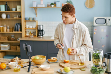 Teenager filming a cooking blog in a modern kitchen with fresh ingredients