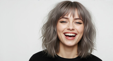 Woman with medium length silver gray hair with straight bangs laughing on white background. Hair coloring and cutting demonstration for salon fantasy color services