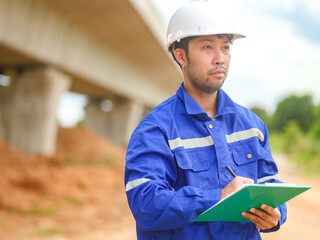 Inspector or engineer is inspecting construction and quality assurance new house using a blue...