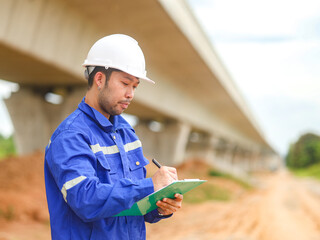 Inspector or engineer is inspecting construction and quality assurance new house using a blue...