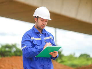 Inspector or engineer is inspecting construction and quality assurance new house using a blue print. Engineer or architects or contactor work to build the house before handing it over to the homeowner