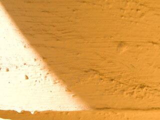 A complex sand colored texture with sun glare