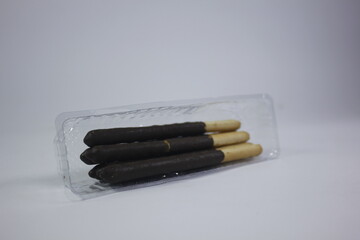 long bread snack covered in chocolate