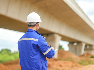 Asian engineer working with tablet at site of a large building project,Thailand people,Work...