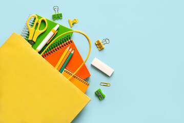 Top view of shopping bag with school supplies and space for text. Back to school concept