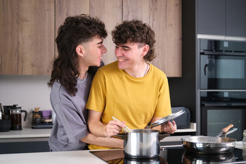 Happy gay couple preparing food in a modern kitchen, enjoying their time together