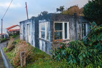 Weathered Concrete House On A Hillside Overlooking The Ocean. Abandoned Building, Rural Landscape,...