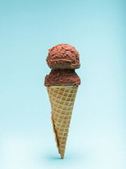 Chocolate Ice Cream in a Waffle Cone. Blue Background.