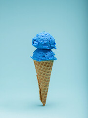 Double Scoop of Blue gum Ice Cream in a Waffle Cone. Blue background