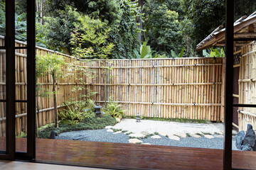 Zen garden bamboo fence stone path green plants peaceful outdoor space t cell cancer