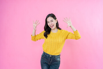 With each pose, the long hair female model in casual wear is taking pictures in a studio with a...