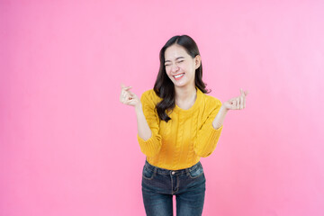 Posing with elegance, the long hair female model wears casual wear while taking pictures in a...