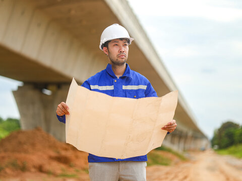 Back one architect standing outdoor at home building construction site