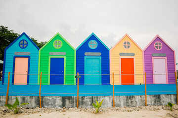 A Vibrant Coastal Scene of Painted Cabanas by the Sea